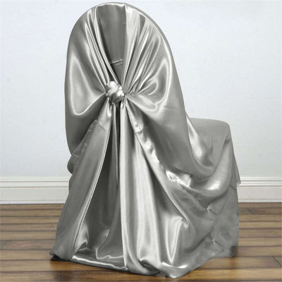 Silver satin chair cover draped elegantly on a wooden chair.