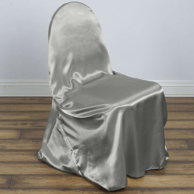 Silver satin chair cover on a wooden floor.