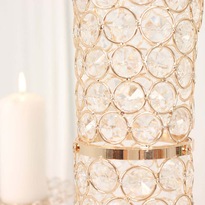 Elegant crystal candle holder with gold accents and intricate design.