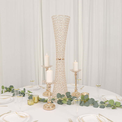 Elegant table centerpiece with candles and greenery for event decor.