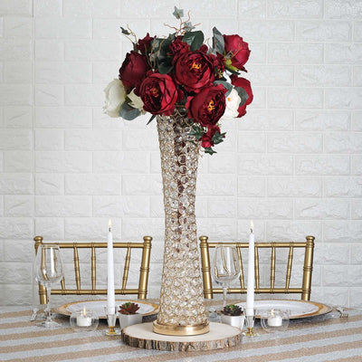Elegant floral centerpiece in a crystal vase with red roses and white blooms.