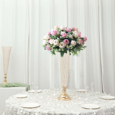 Elegant floral centerpiece in a tall vase with pink and white roses.
