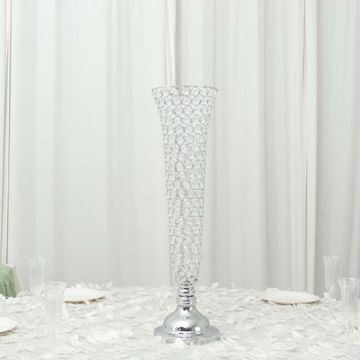 Elegant crystal vase on a table with floral decor.