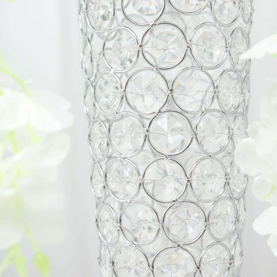 Crystal vase with circular silver details and sparkling gems.