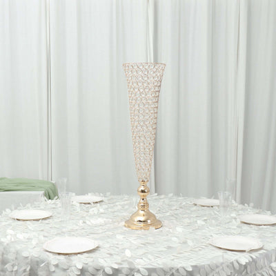 Elegant gold vase centerpiece on a decorated table
