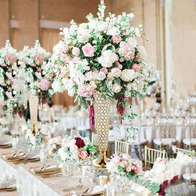 Elegant floral centerpieces in a luxurious wedding setting with pink and white blooms.