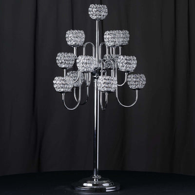 Elegant chrome candelabra with crystal candle holders against a dark backdrop.