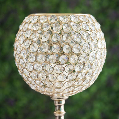 Elegant crystal candle holder with gold accents and intricate detailing.