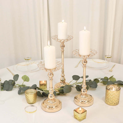 Elegant candle holders with white candles and decorative accents on a table.