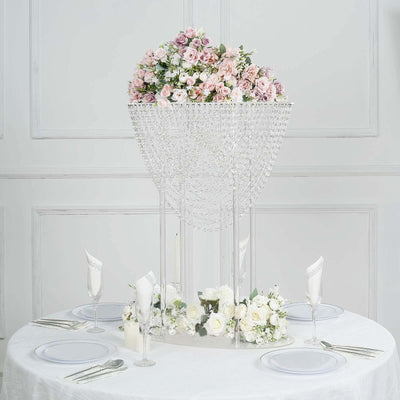 Elegant floral centerpiece with crystals on a dining table setting.