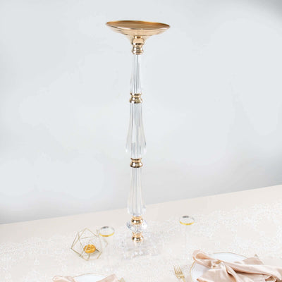 Elegant tall crystal candle holder with gold accents on a white backdrop.