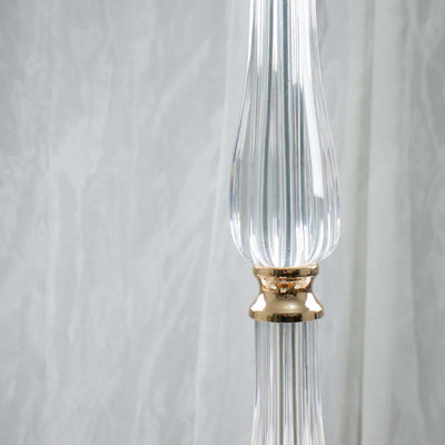 Elegant glass lamp with gold accents and ribbed design.