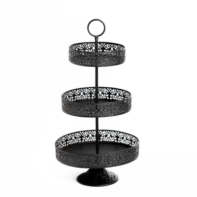 Black three-tiered serving stand with intricate lace pattern.