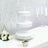 White three-tiered serving stand with decorative lace design.