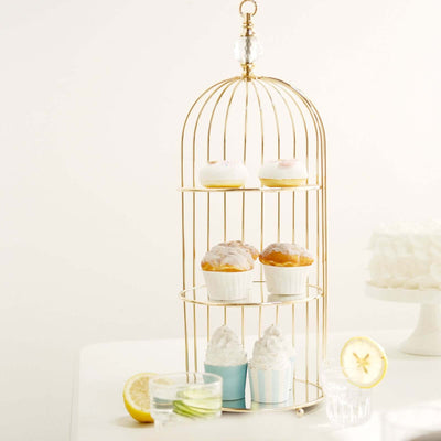 Gold cupcake stand with assorted desserts and lemon slices
