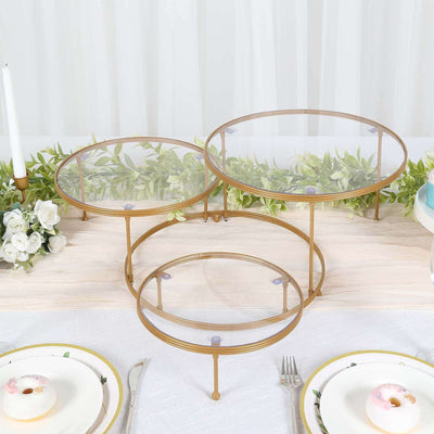 Three-tiered dessert display stand with glass and gold metal accents.