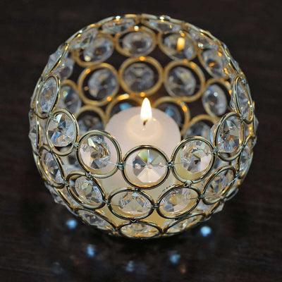 Elegant crystal candle holder with a lit candle inside.