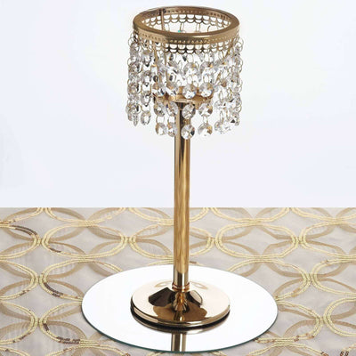 Elegant gold candle holder with crystal embellishments on a mirrored base.