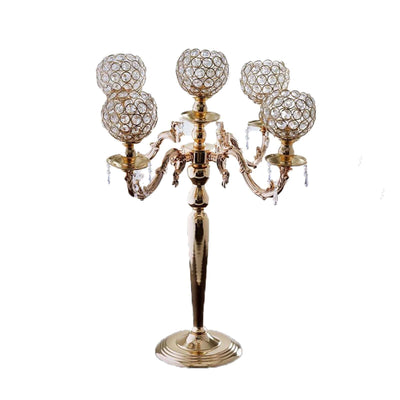 Elegant crystal candelabra with five candle holders on a gold base.