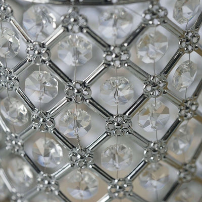 Crystal-embellished candle holder with intricate silver detailing.