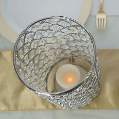 Elegant crystal candle holder on a golden table runner.
