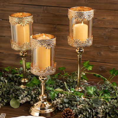 Elegant gold candle holders with decorative accents and candles, styled on a rustic table.
