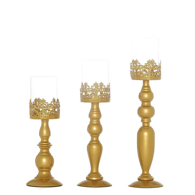 Gold decorative candle holders in three varying heights