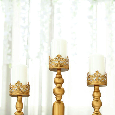 Elegant gold candle holders with white candles, set against a soft, bright background.