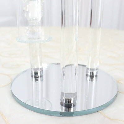 Clear acrylic table lamp with mirrored base and elegant design.