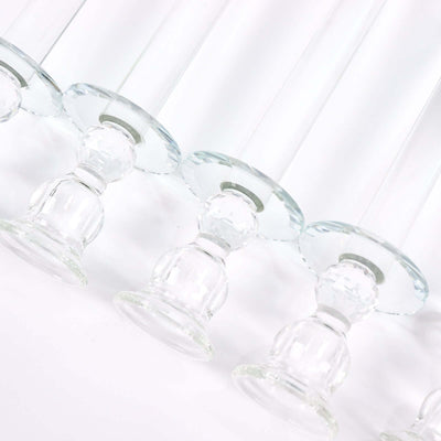 Set of elegant glass candlestick holders on a white background.