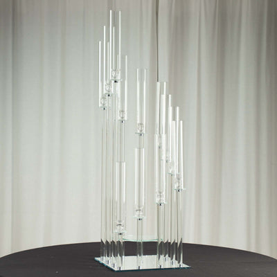Elegant glass candle holder sculpture with varying heights.