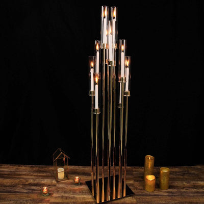 Elegant tall candle holder with multiple glass tubes and lit candles.