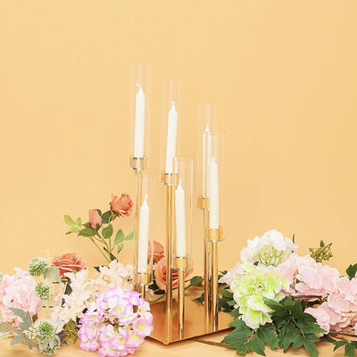 Elegant gold candle holder with flowers, perfect for home decor or events.