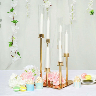 Elegant candle holder centerpiece with flowers and desserts on a table.