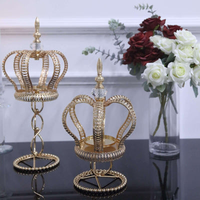 Gold decorative crown candle holders with crystal accents.