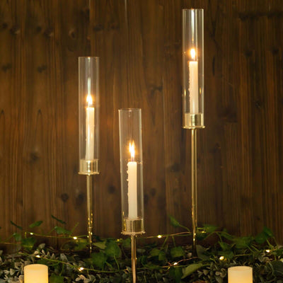 Elegant candle holders with lit candles, set against a wooden backdrop.