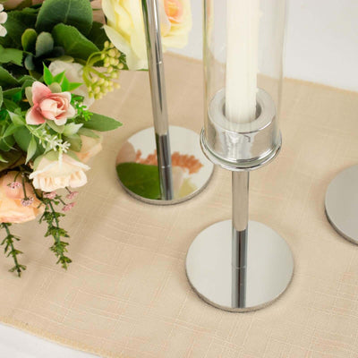 Candle holders with floral arrangement on a table setting.