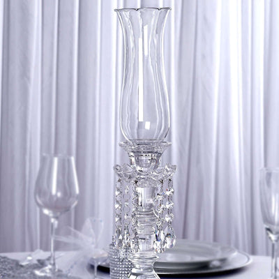 Elegant crystal candle holder with decorative beads.