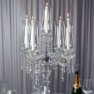 Elegant crystal candelabra with five candles, perfect for wedding decor.