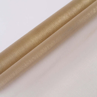 Gold and white sheer fabric rolls stacked together