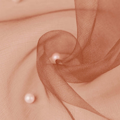 Soft peach fabric with delicate pearls scattered throughout.