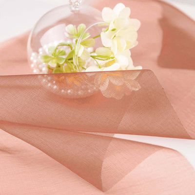Peach organza fabric draped elegantly with floral accents.