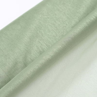 Light green fabric draped elegantly on a white background.