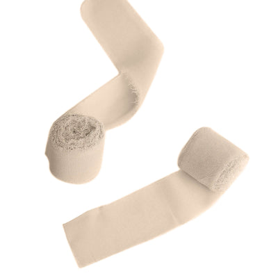 Beige elastic bandages rolled and unrolled on a white background.