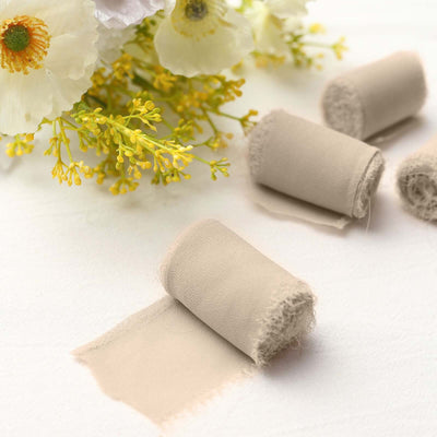 Beige fabric rolls with flowers on a light background.