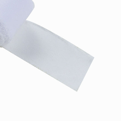White adhesive bandage roll on a plain background