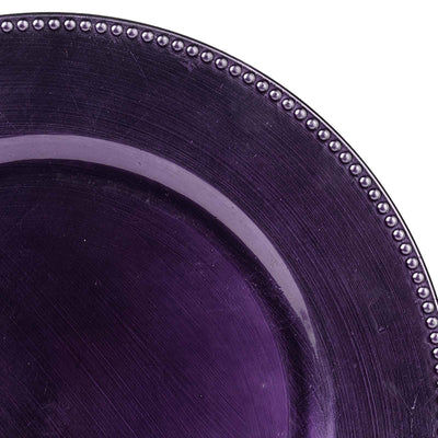 Purple decorative plate with beaded rim detail.