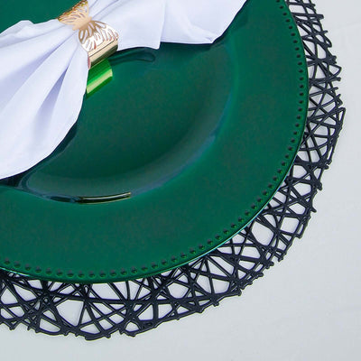 Green plate with black lace placemat and white napkin.