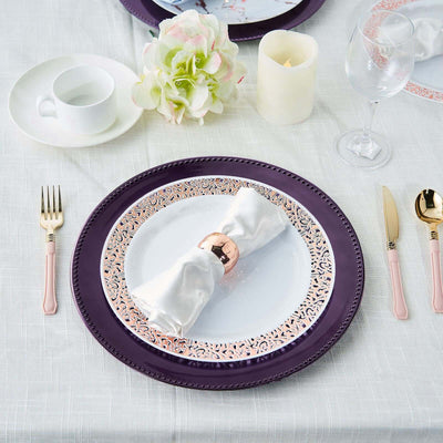 Elegant table setting with decorative plates and napkin holder.