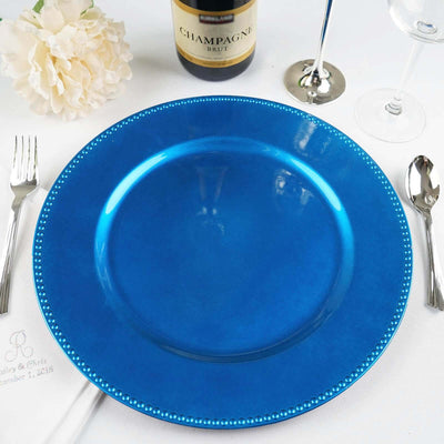 Blue decorative charger plate on a dining table setting.